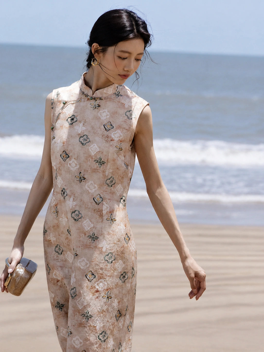 Back view of a sleeveless floral Mandarin collar midi dress.