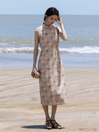 Full-length view of a sleeveless floral midi dress styled for a seaside holiday.