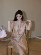 Sitting view highlighting the silky sheen of the mulberry silk fabric and the delicate butterfly jacquard pattern, featuring a sleeveless design.