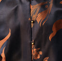 Close-up of the lustrous dark jacquard fabric with antique bronze goldfish and floral motifs