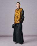 Full-length front view of an antique gold botanical jacquard vest with traditional frog buttons