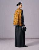Back view of the antique gold floral jacquard Chinese vest showing its relaxed straight silhouette
