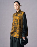 Three-quarter view of the antique gold floral jacquard vest styled over a black blouse