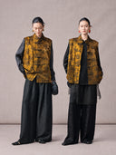 Two women styling the antique gold Mandarin collar jacquard vest with black outfits