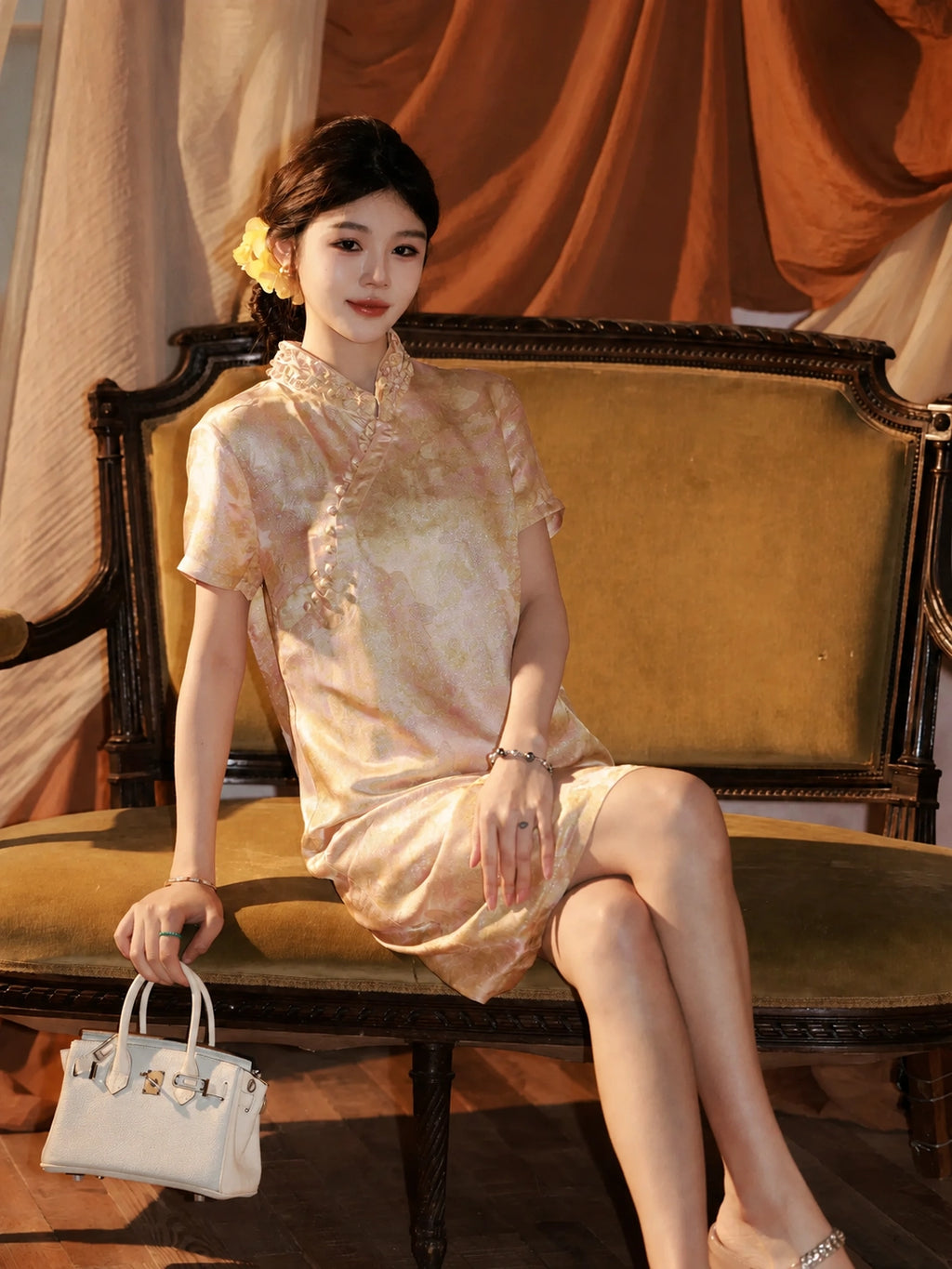 Model wearing an apricot mulberry silk dress with a stand collar and elegant short sleeves