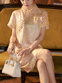 Close-up of the apricot silk dress showing the stand collar, diagonal button front and floral texture
