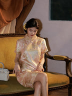 Model seated in an apricot qipao-inspired silk dress with a fitted A-line silhouette