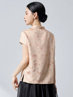 Back view of an apricot mulberry silk top with a stand collar, butterfly jacquard pattern, and a relaxed A-line fit, showcasing the 23 momme luxury fabric.