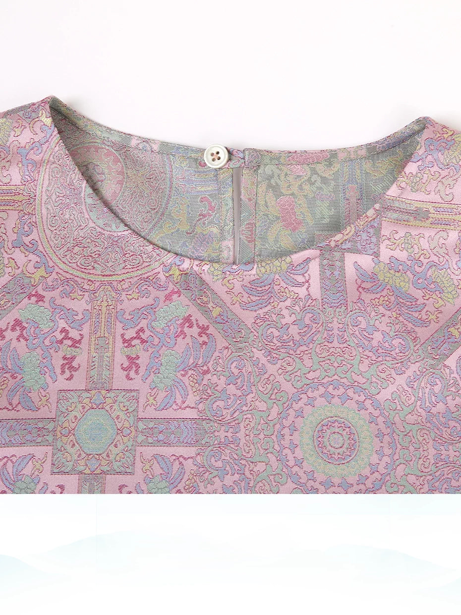 Close-up of a dusty rose Song brocade silk dress showing the round neckline and woven Badayun motif
