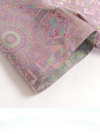 Close-up of Badayun Song brocade fabric with pastel geometric and floral motifs