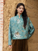 Closer front view of the Baishi jacket showing floral jacquard, embroidered stems, sequins and pale piping.
