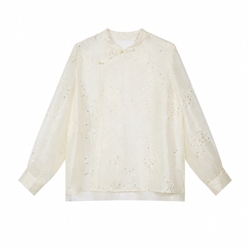 Flat lay of a beige long-sleeve Cheongsam blouse with a mandarin collar, floral embroidery, and sequin details, crafted from 100% polyamide.