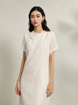 Women's beige mulberry silk floral shift dress with handcrafted frog button closure.