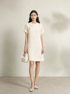 Model wearing an beige 100% mulberry silk floral shift dress with a relaxed silhouette.