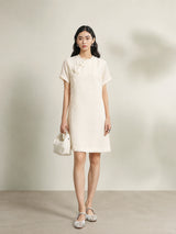 Model wearing an beige 100% mulberry silk floral shift dress with a relaxed silhouette.