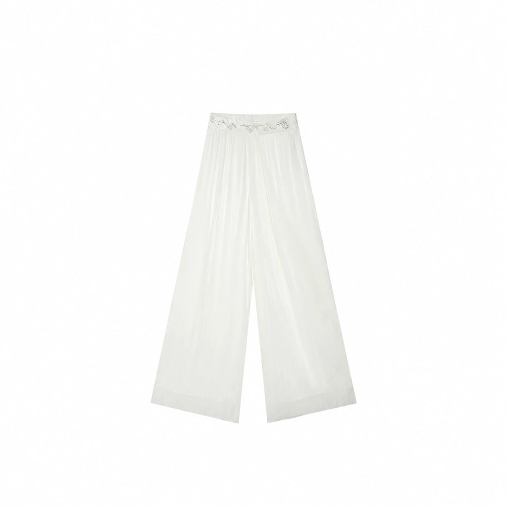 Flat lay of Beige pleated wide-leg pants with a delicate floral embroidered waistband, crafted from 100% polyester.