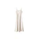 Flat lay of a beige satin slip dress with metallic strap details and a loose A-line silhouette, crafted from 100% polyester.