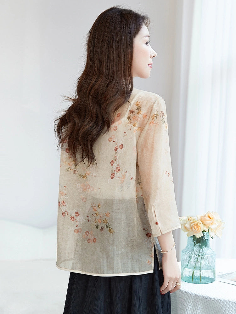 Back view of a beige 100% silk blouse with a relaxed fit and floral print, highlighting the elegant drape and breathable feel.