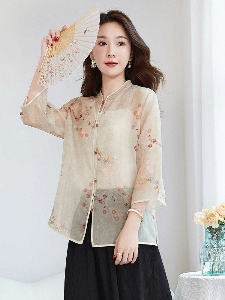 Model wearing a beige silk Cheongsam-style top with a stand collar, holding a folding fan over her face, showcasing the elegance and cultural charm of the design.