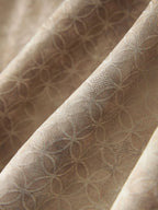 Close-up of the beige viscose fabric showing its subtle geometric jacquard pattern and textured finish.