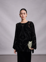 Close-up of black burnout mulberry silk blouse with sheer floral velvet pattern.