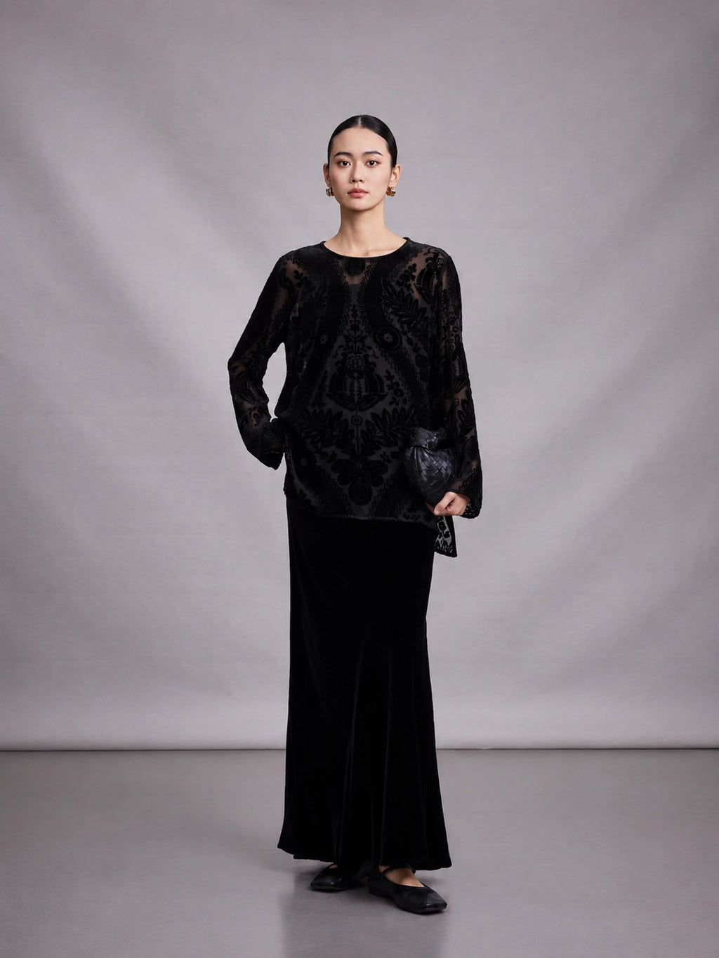 Women's black 100% mulberry silk burnout blouse with long sleeves, front full-body view.