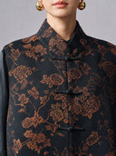 Close-up of the Mandarin collar, copper floral jacquard and traditional frog-button closures