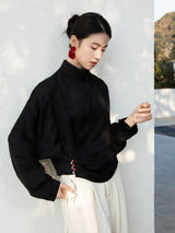 Side profile of the Black Cross-Over Mandarin Collar Blouse with decorative button details.