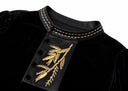 Close-up of the gold botanical embroidery and fabric-covered buttons