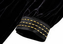 Close-up of the gold-stitched cuff and gathered black sleeve