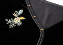 Detail of the gold, ivory and blue-green floral embroidery beside the neckline