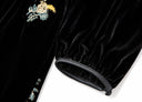 Close-up of the gathered sleeve cuff on the black dress