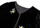 Close-up of the V neckline, tonal trim and floral embroidery