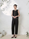 Full body shot of a black silk co-ord set featuring a sleeveless vest top with gold geometric embroidery along the neckline, center front, and hem, paired with matching straight-leg trousers, crafted from 100% mulberry silk.