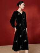 Angled view showing the V neckline and scattered floral embroidery