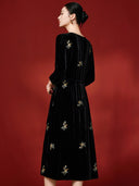 Back view of the black midi dress with floral embroidery