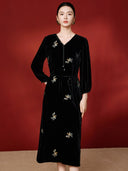 Front view of a black floral embroidered midi dress with a self-tie waist