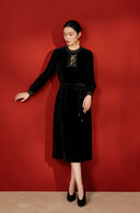 Full-length view of the black gold-embroidered midi dress