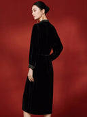 Back view of the black midi dress showing its waist tie and long sleeves