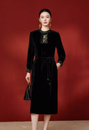 Front view of the black dress with an embroidered placket and self-tie waist