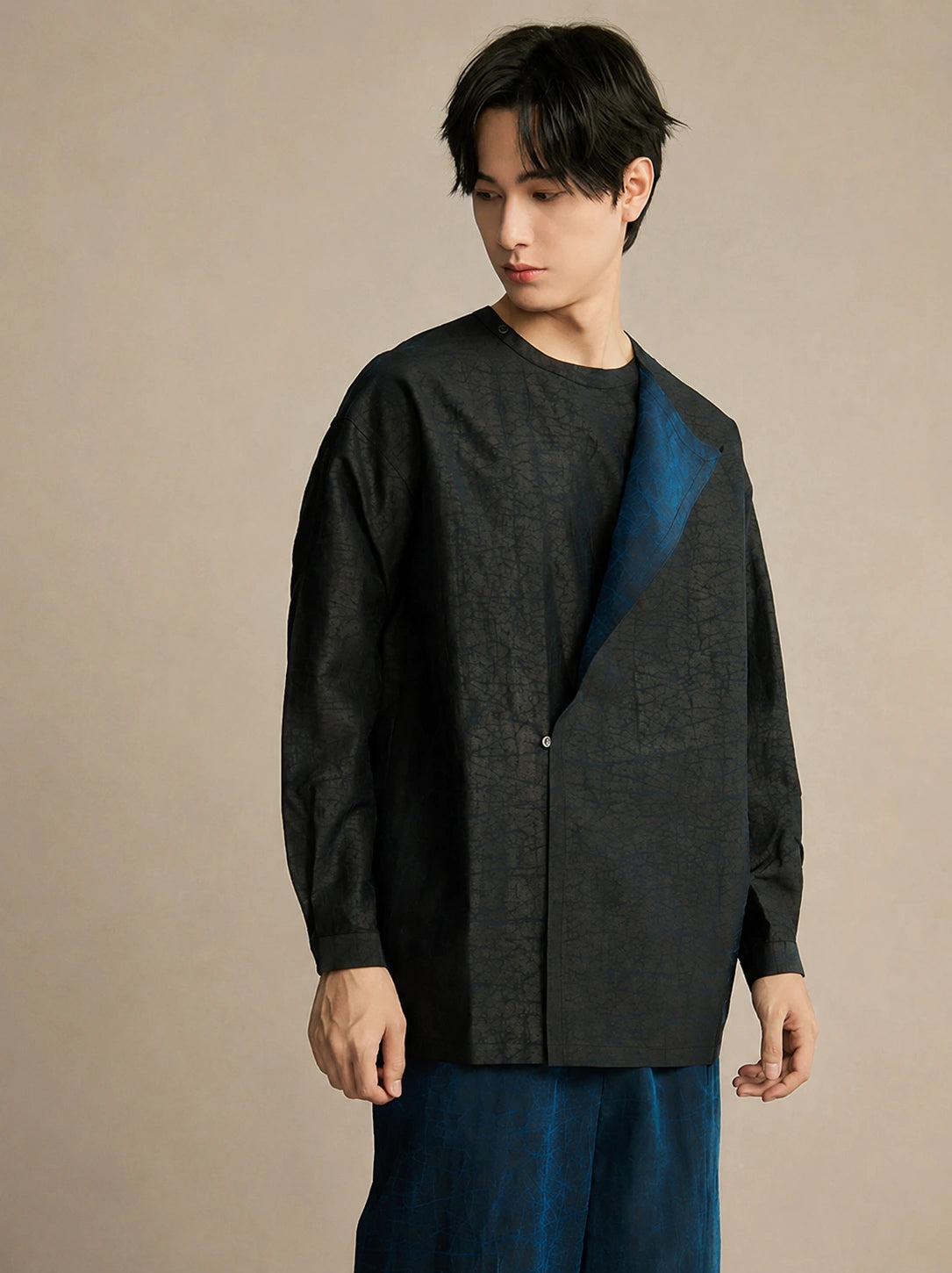 Men's black mulberry silk asymmetric shirt featuring a modern layered lapel and relaxed silhouette.