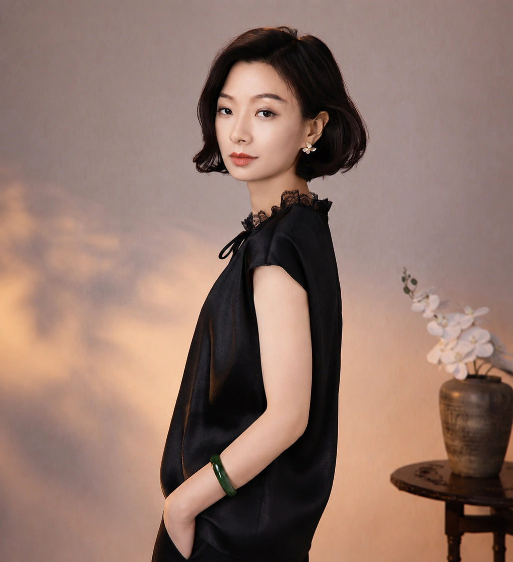 Side view of a black mulberry silk blouse showing its fluid drape, lace collar and relaxed fit