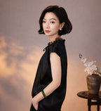 Side view of a black mulberry silk blouse showing its fluid drape, lace collar and relaxed fit