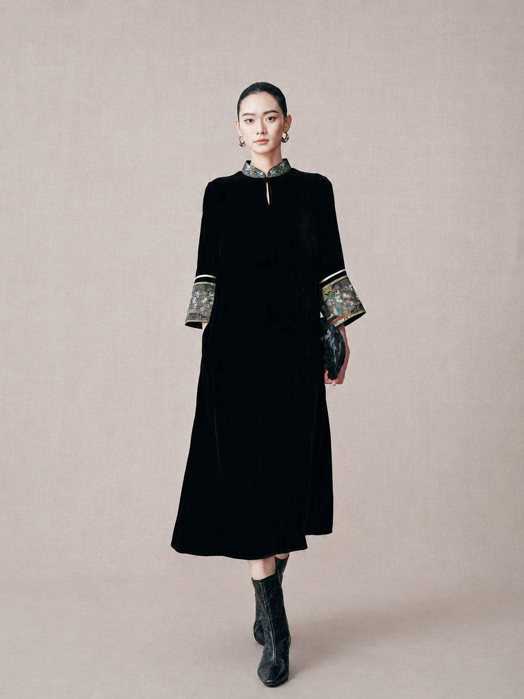 Model wearing a black mulberry silk mandarin collar dress with embroidered brocade cuffs