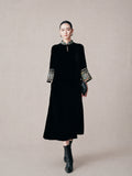 Model wearing a black mulberry silk mandarin collar dress with embroidered brocade cuffs