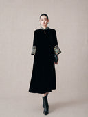 Model wearing a black mulberry silk mandarin collar dress with embroidered brocade cuffs