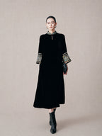 Model wearing a black mulberry silk mandarin collar dress with embroidered brocade cuffs