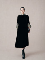 Model wearing a black mulberry silk mandarin collar dress with embroidered brocade cuffs