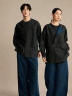 Black 100% mulberry silk unisex designer shirt styled on male and female models with a modern asymmetric collar.