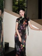 Black rayon jacquard long qipao with diagonal front closure, floral print, cap sleeves, and green contrast trim.